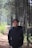 man in black jacket standing in forest during daytime