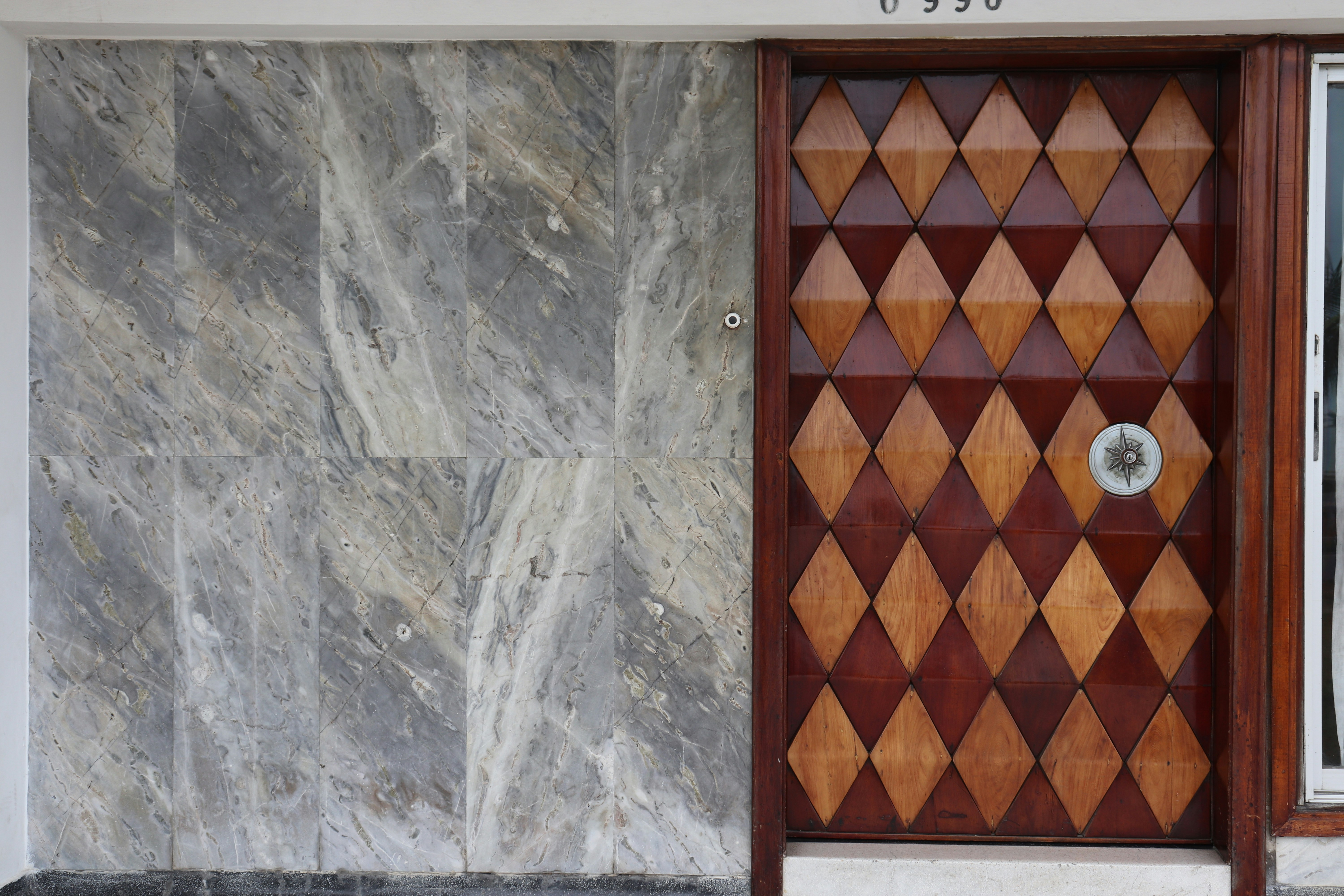 brown wooden door on gray concrete wall