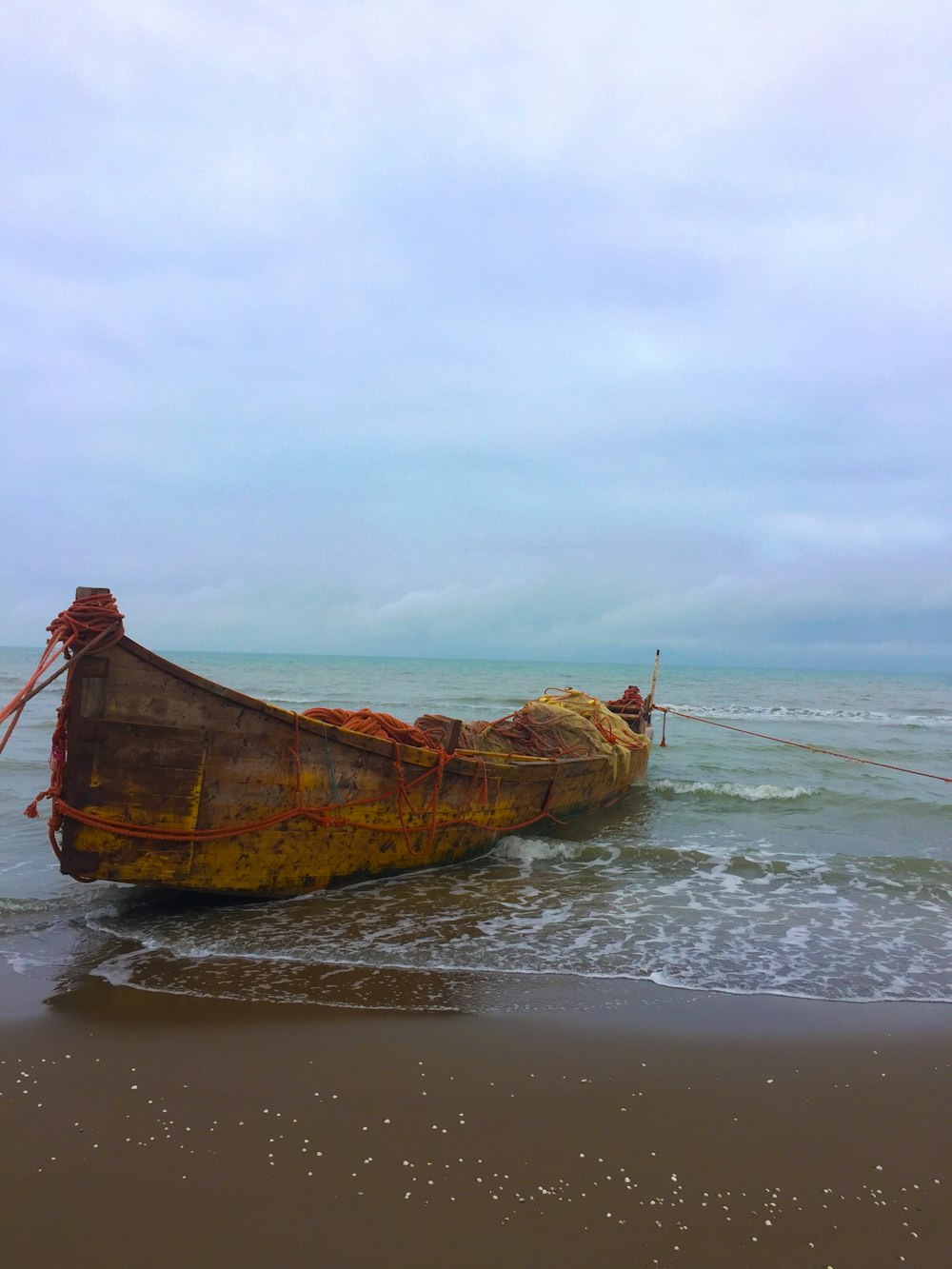 brown wooden boat on sea during daytime