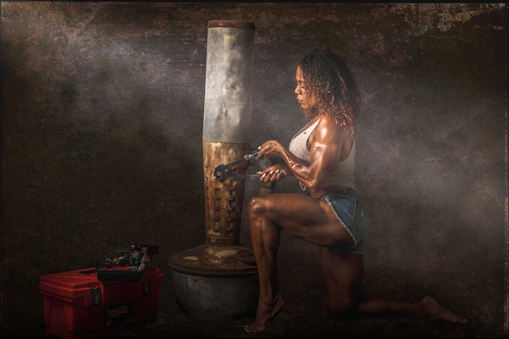 woman in black tank top sitting on brown wooden armchair