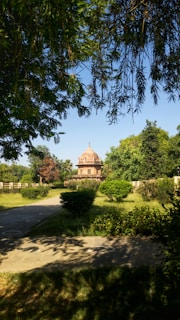 A serene view of a historical garden with lush greenery and traditional architecture.