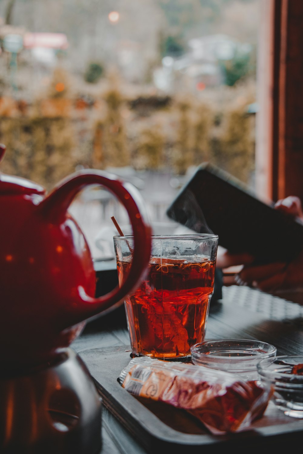 clear glass mug with brown liquid on table