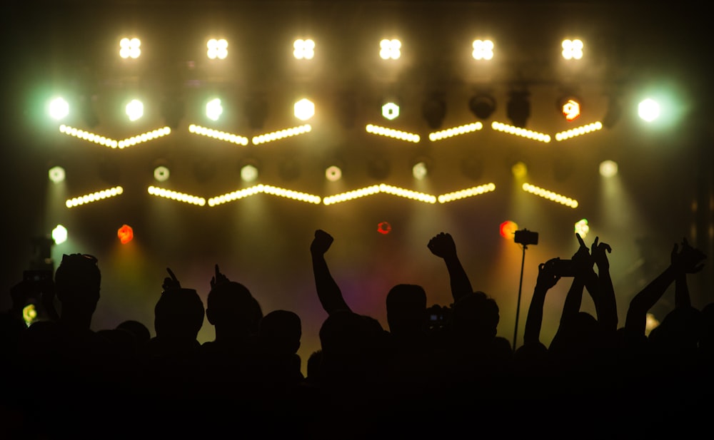 silhouette of people standing on stage