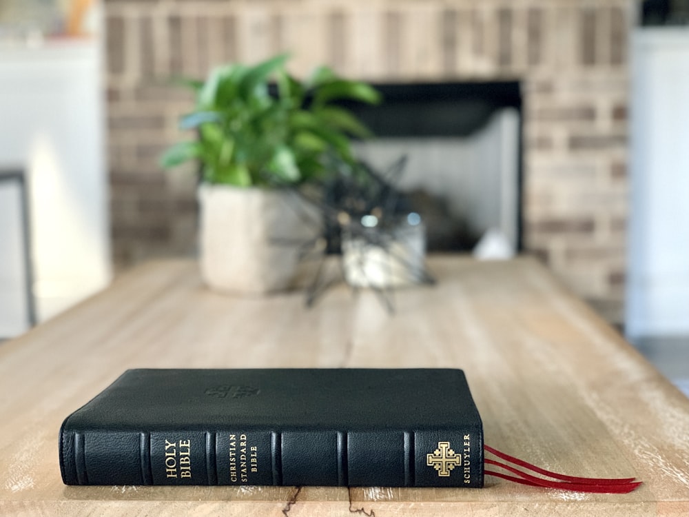 black book on brown wooden table