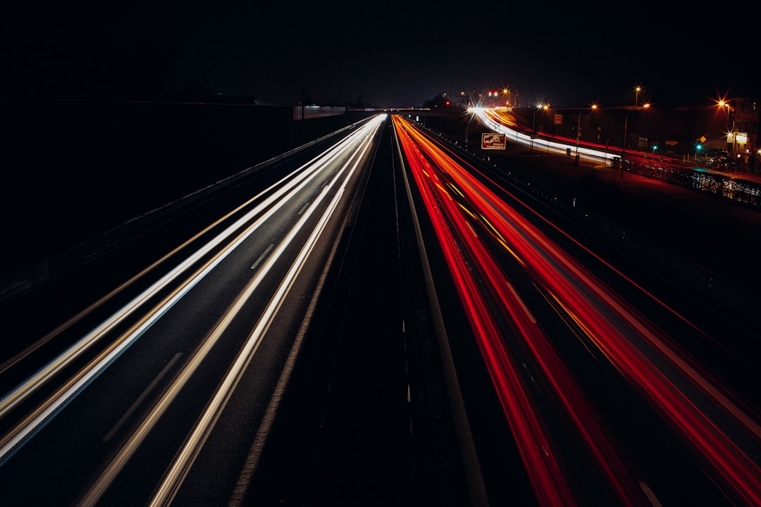 Highway at night with red and white light trail
