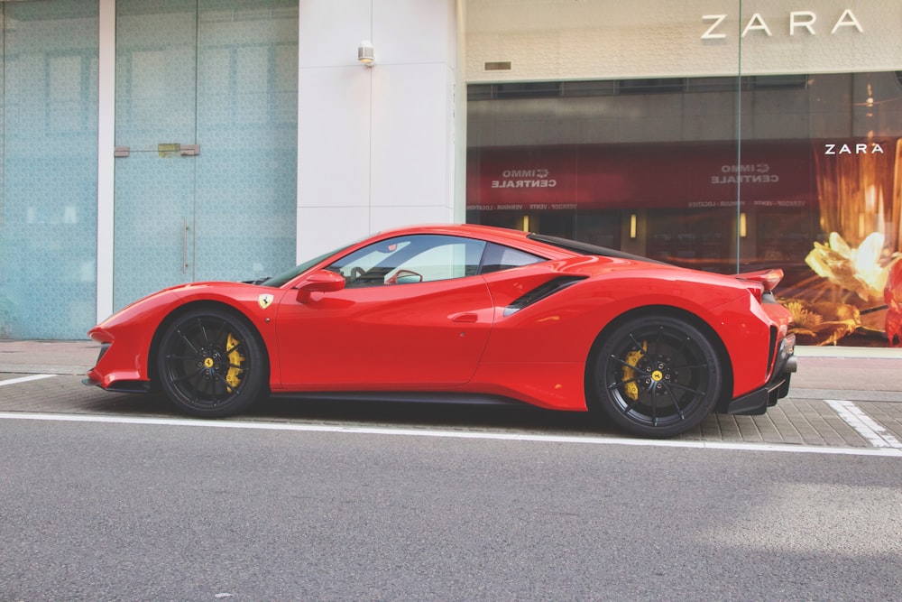 red ferrari 458 italia parked near building