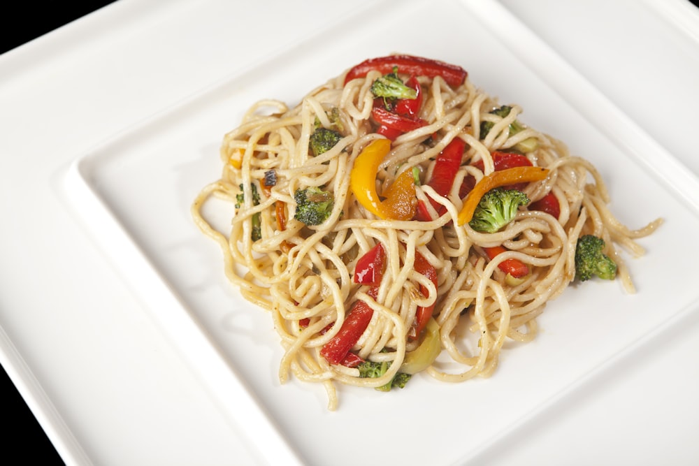 spaghetti with red sauce on white ceramic plate