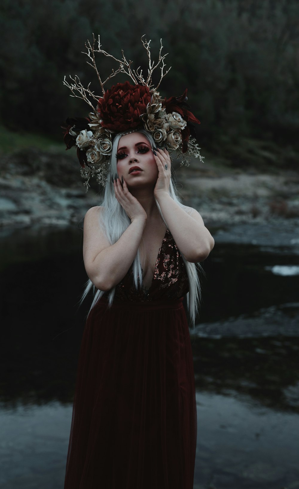 woman in red and black sleeveless dress with red and gold floral headdress