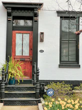 Installation of a sturdy security door at a home entrance by a professional.