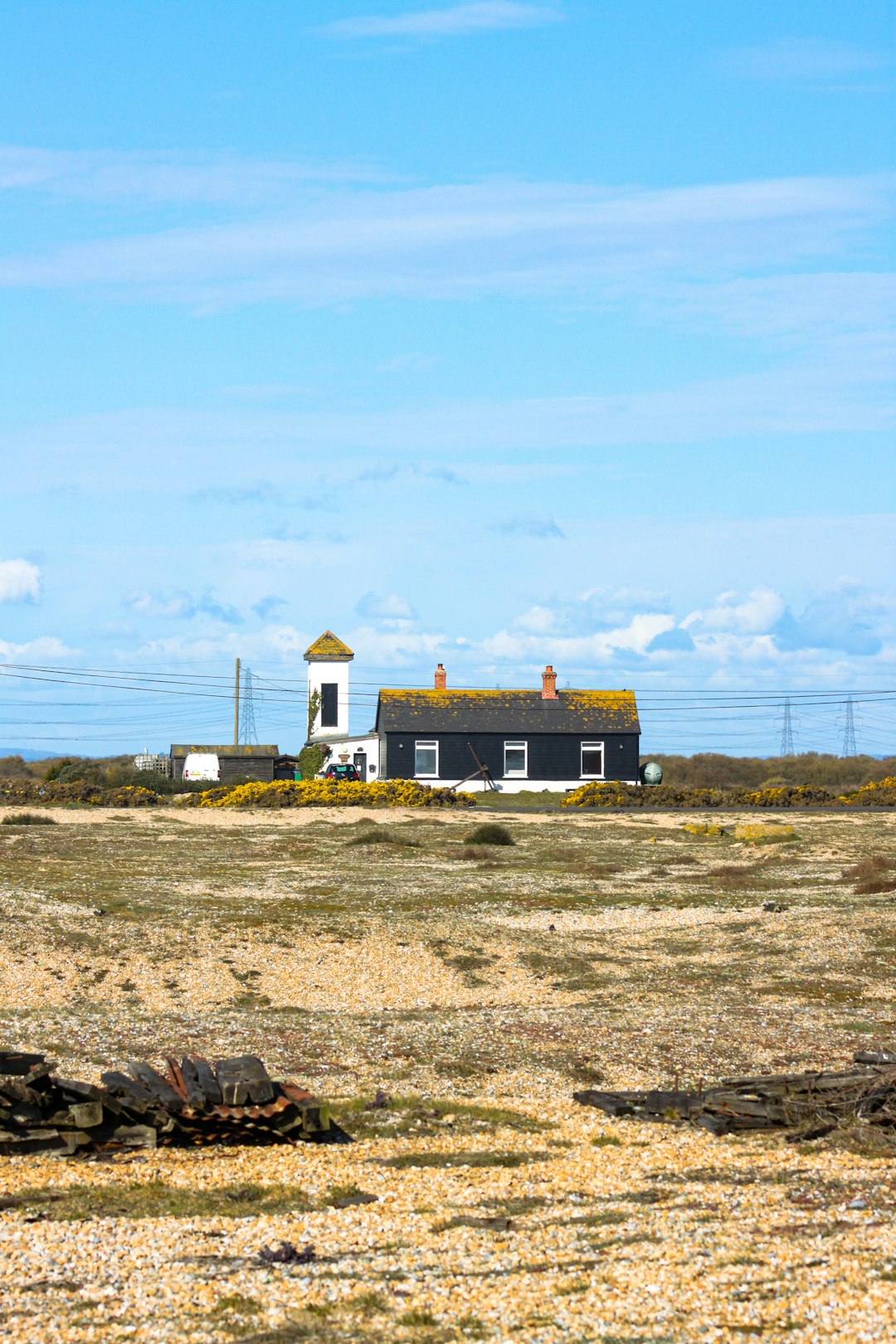 white and brown house on brown field under blue sky during daytime