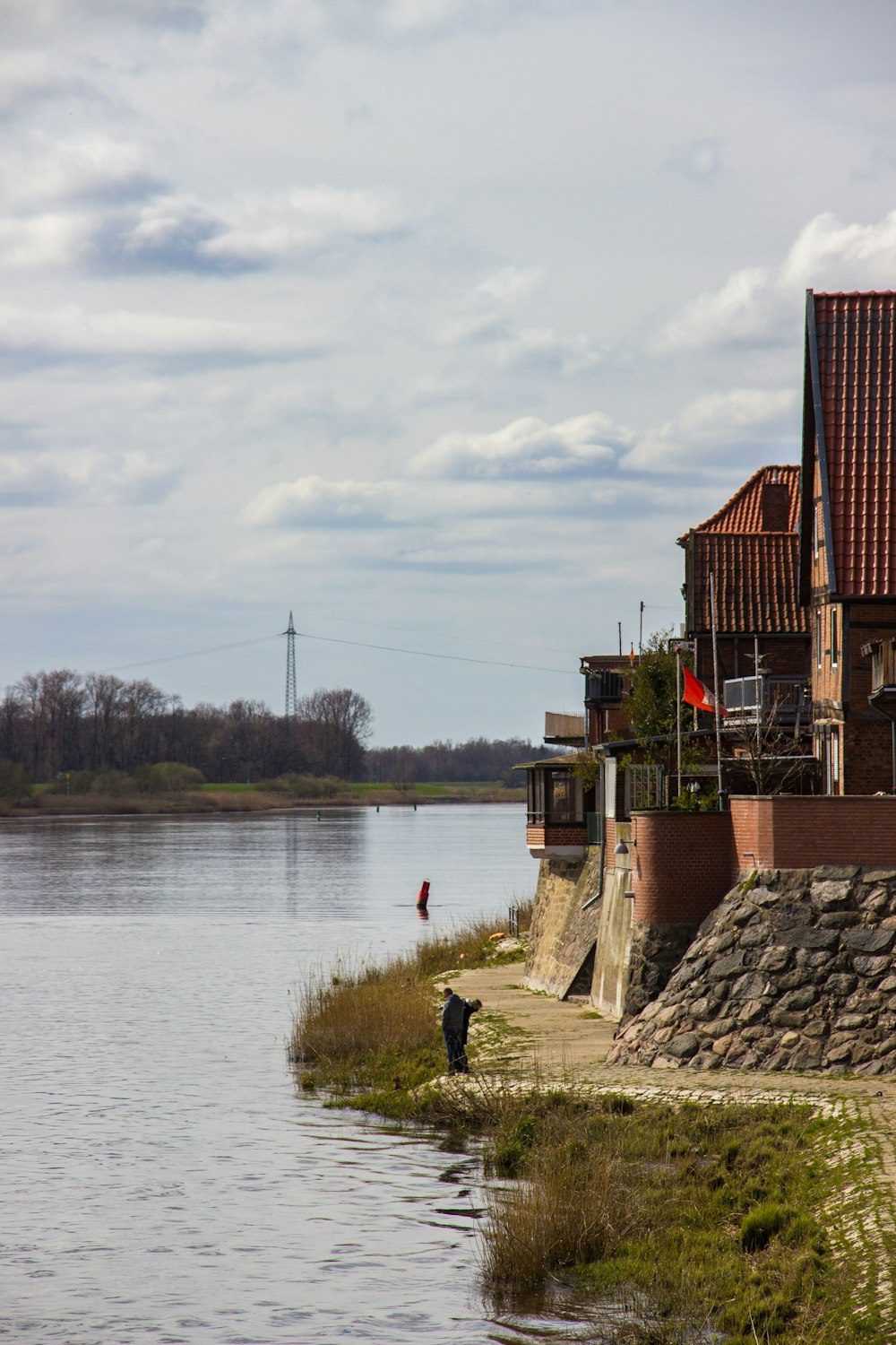 brown brick building near body of water during daytime