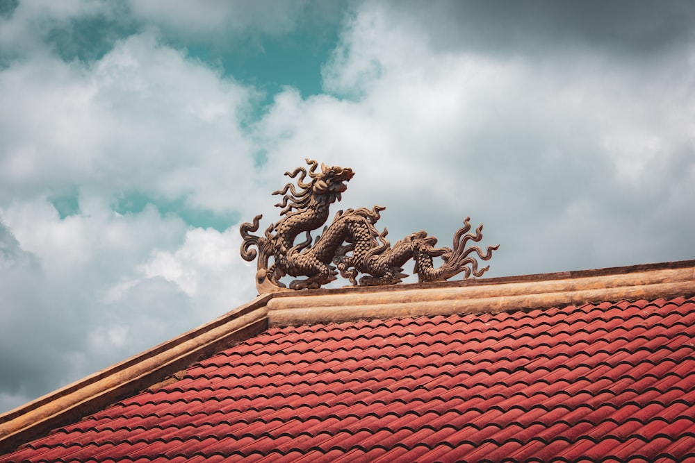 brown concrete dragon statue on roof