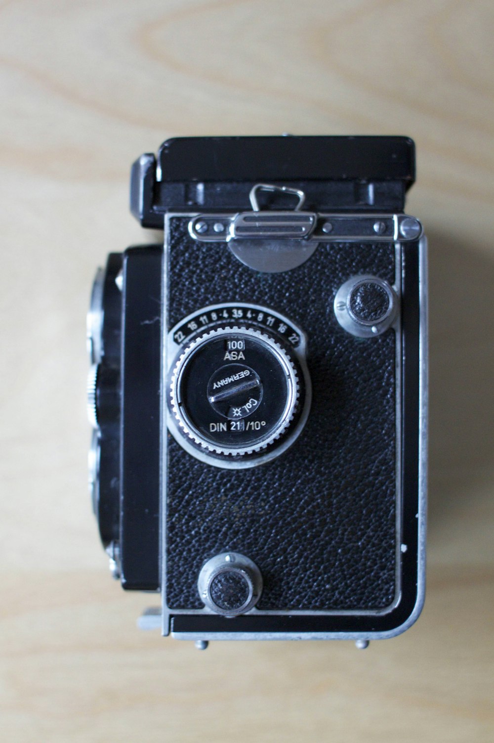 black and silver camera on brown wooden table