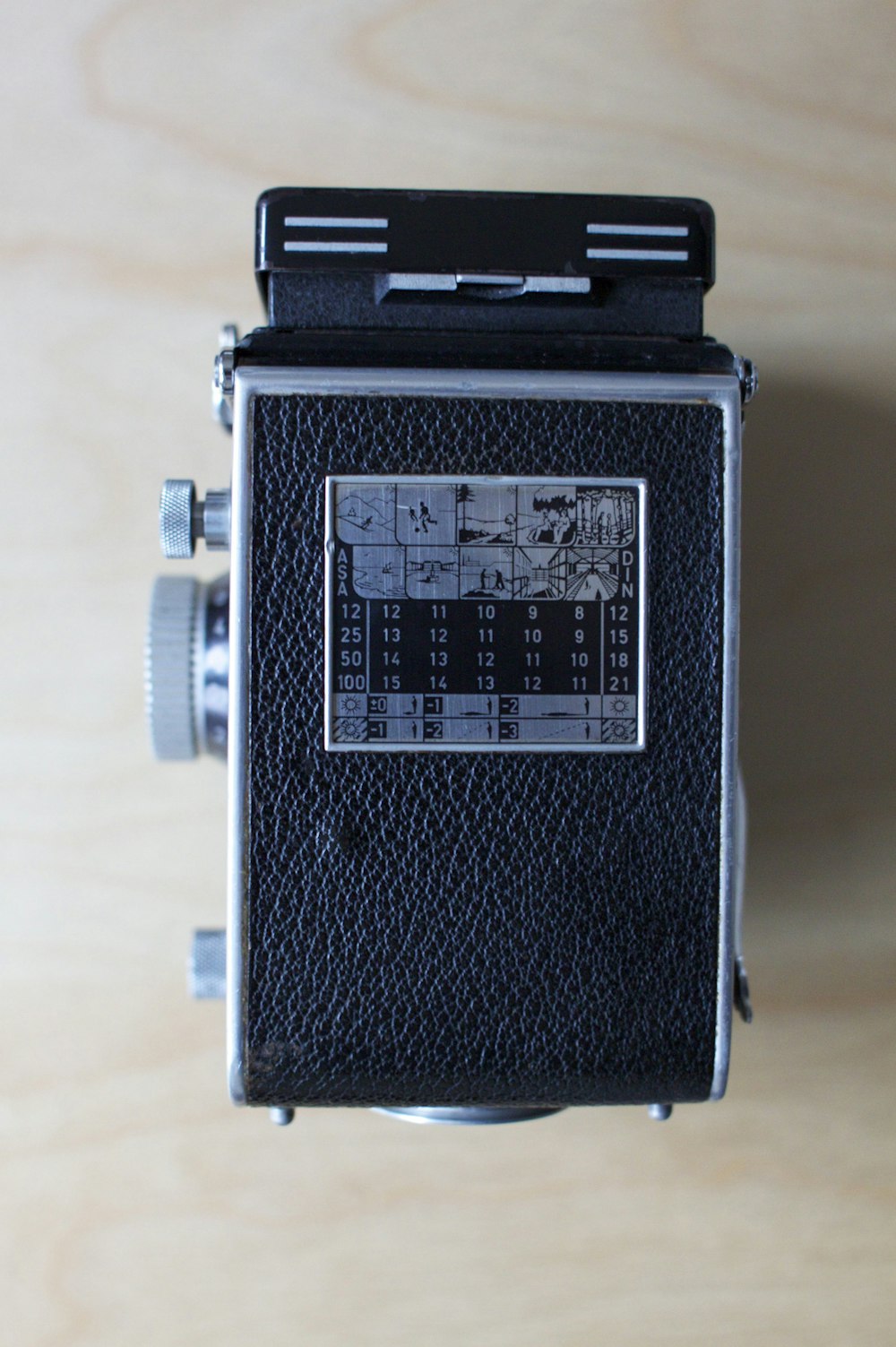 black and silver camera on white table