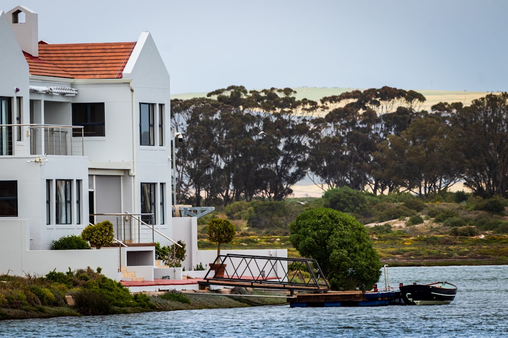 white and red concrete building near body of water during daytime