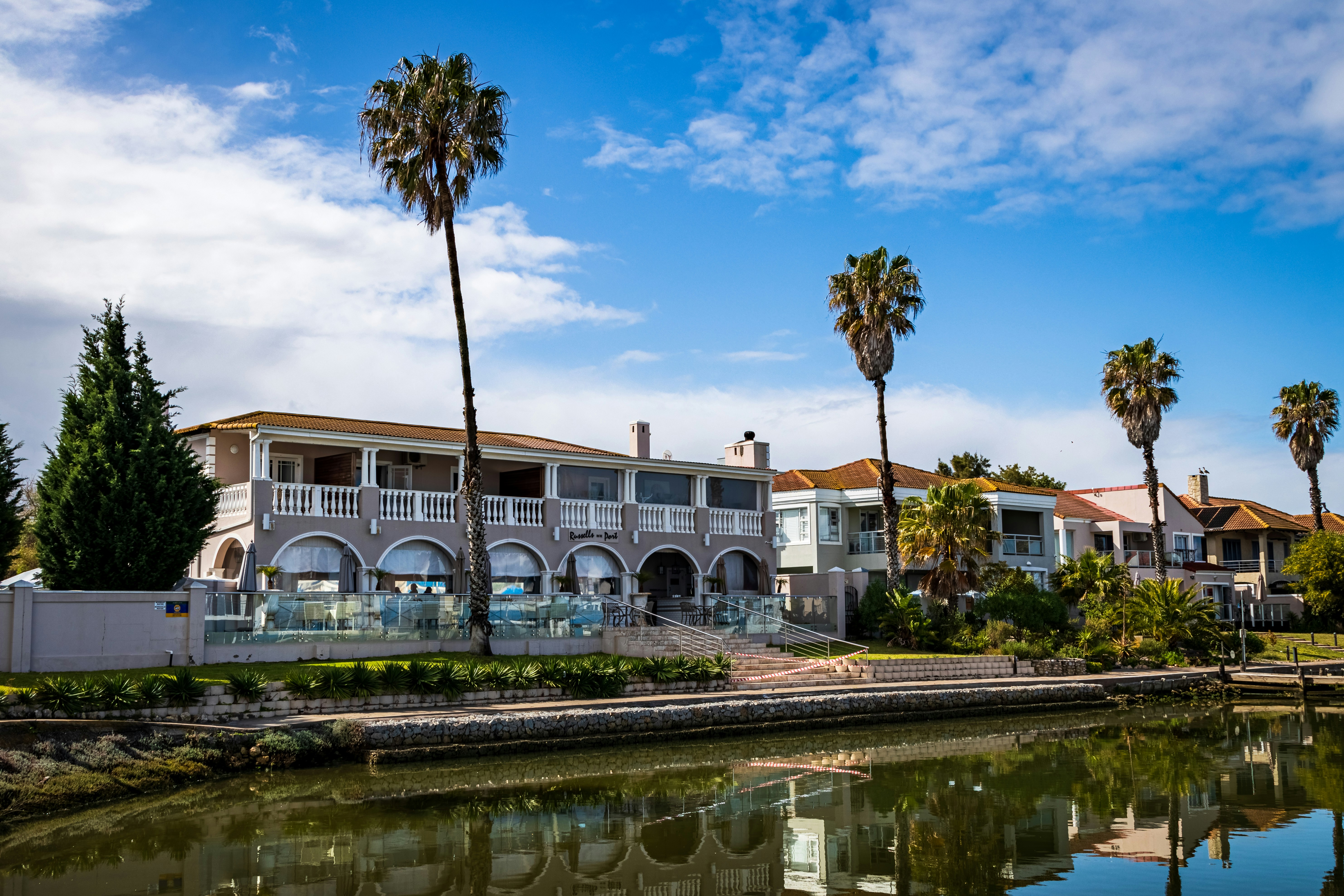 white and brown concrete building near river during daytime