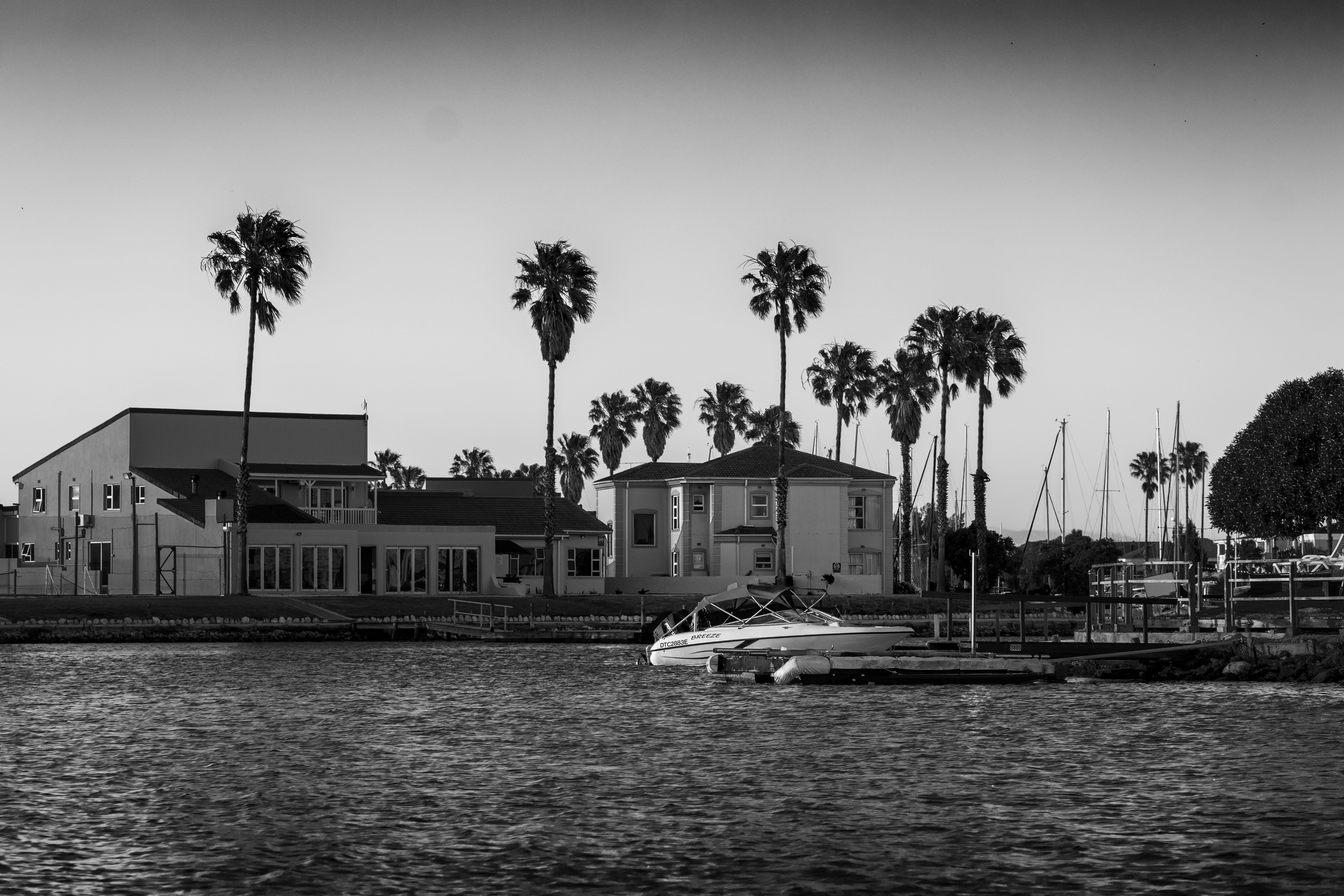 grayscale photo of a boat on a lake