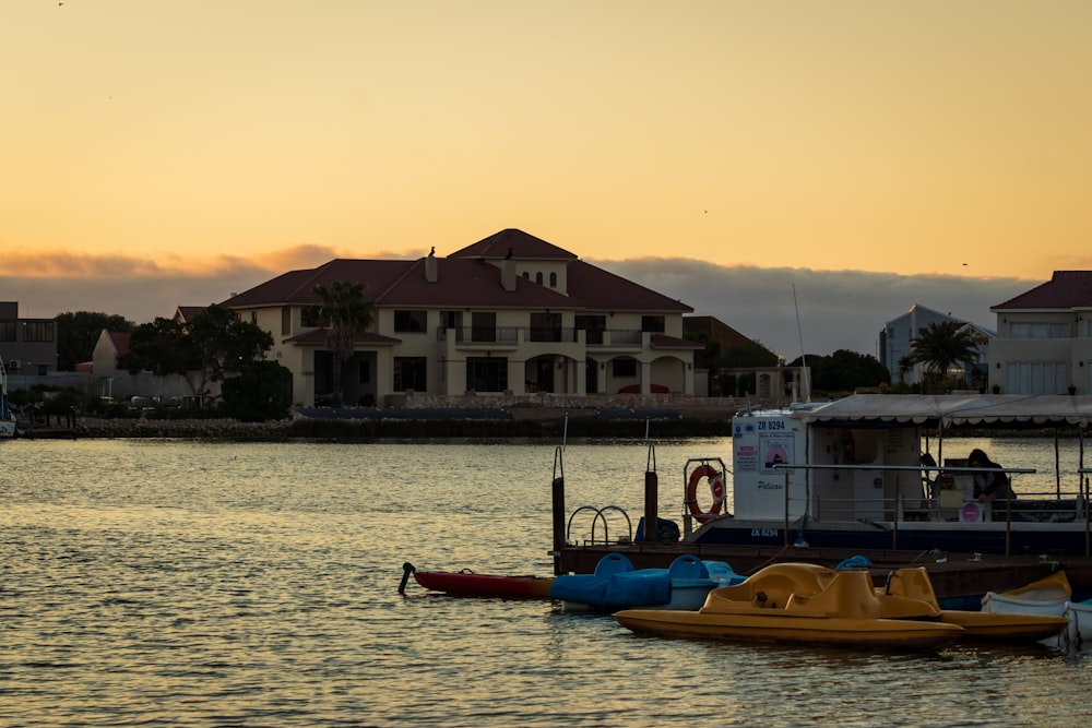 white and brown concrete house beside body of water during daytime