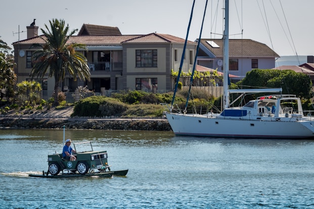 man in green shirt riding on green and white boat during daytime
