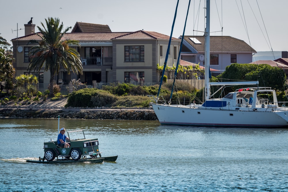 man in green shirt riding on green and white boat during daytime