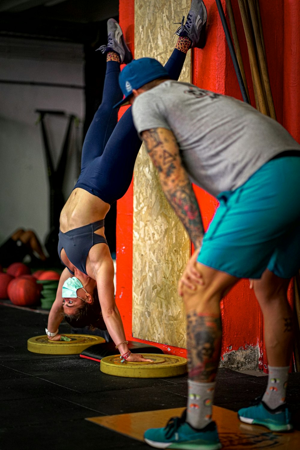 man in gray shirt and blue shorts doing yoga
