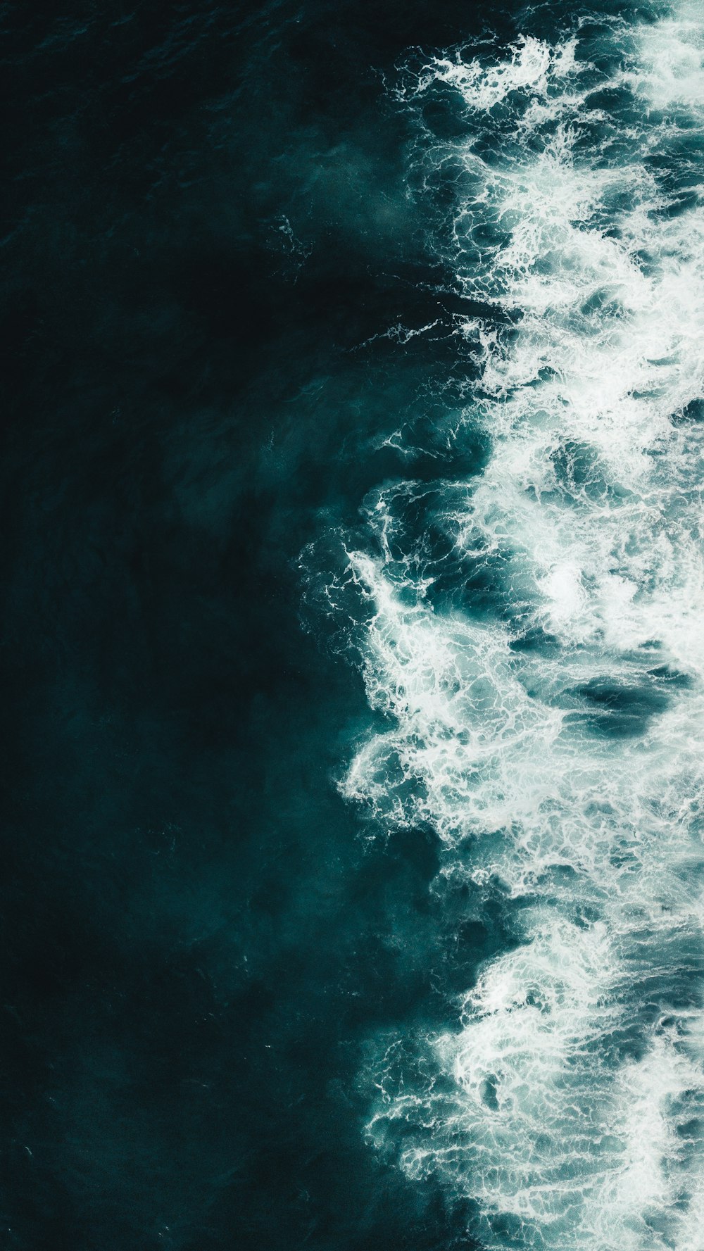 ocean waves crashing on shore during daytime