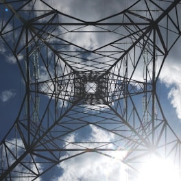 Close-up of a clean overhead transmission line after professional washing, with water droplets sparkling in sunlight.