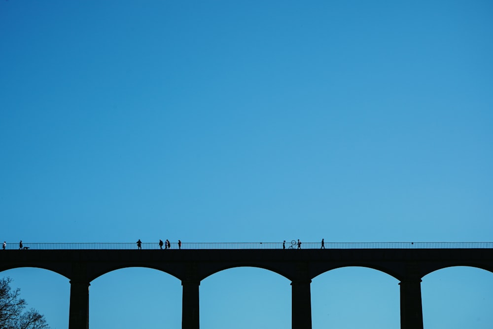 gray concrete bridge under blue sky during daytime