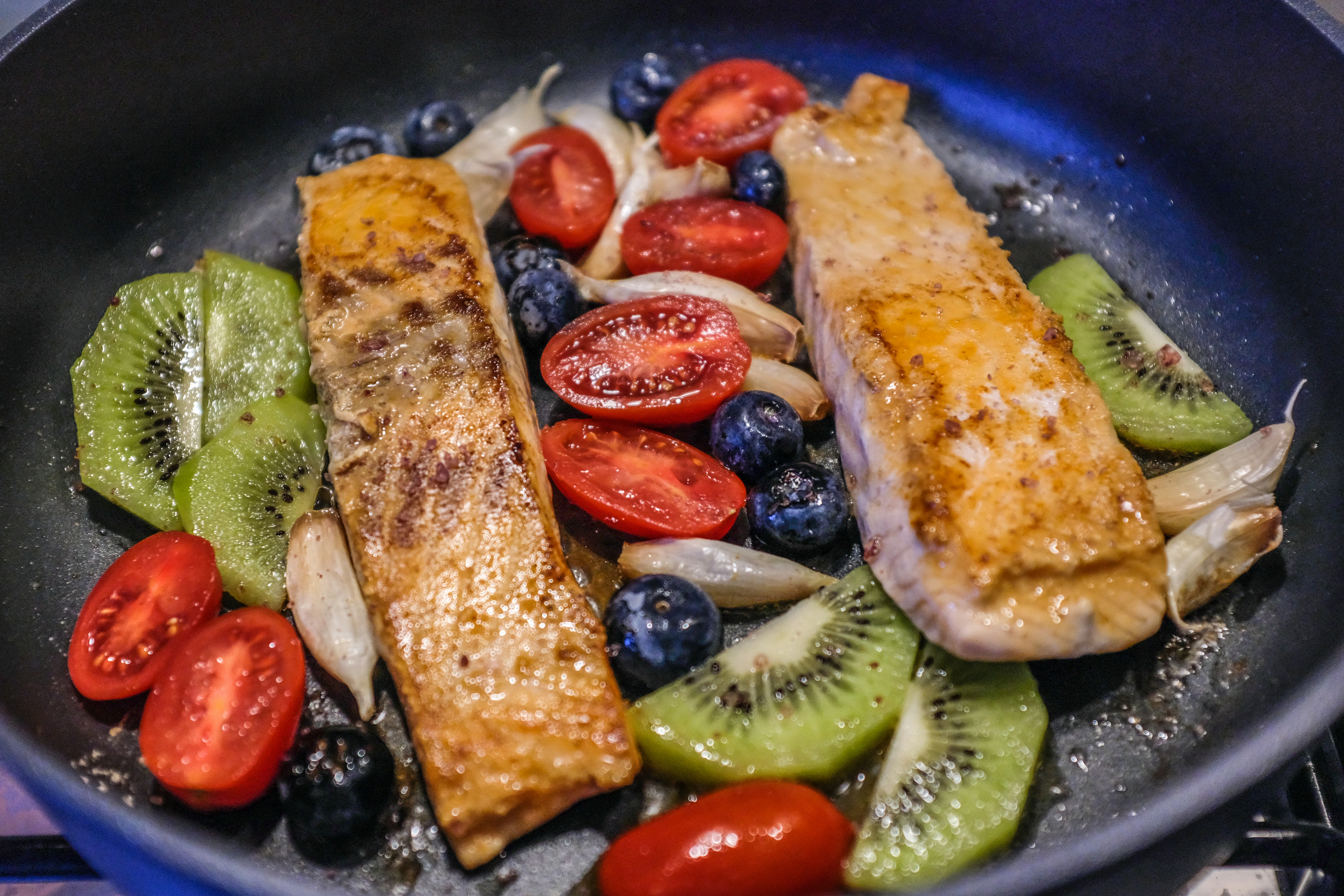 Pan-seared salmon with berries, tomatoes, and kiwi — fertility-friendly whole foods