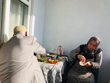 An elderly couple enjoying a healthy meal together at home.