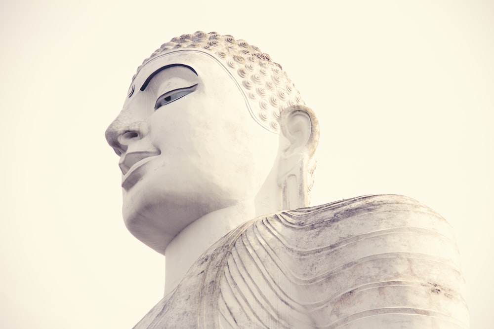 white concrete statue of a man