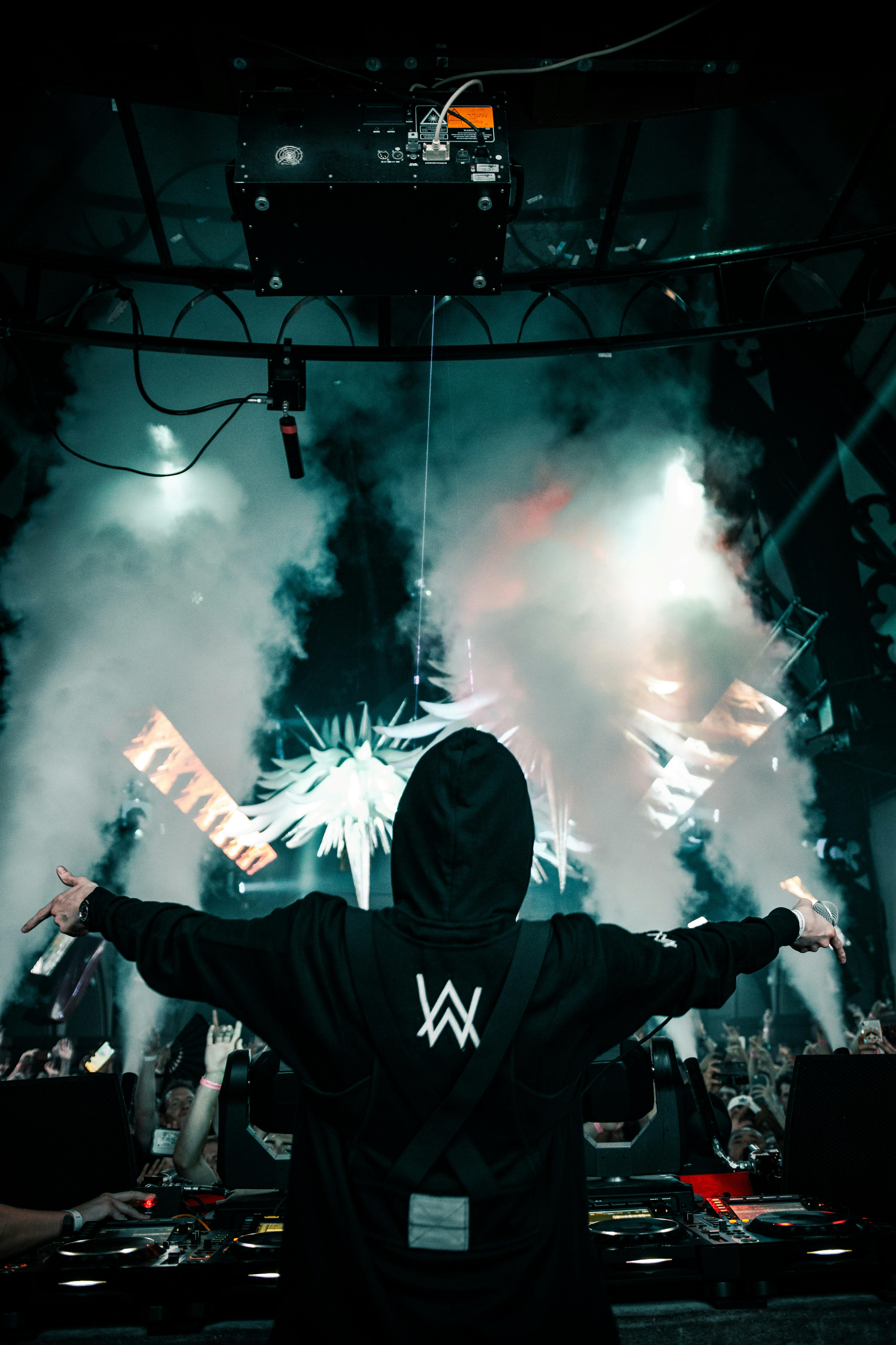 man in black hoodie raising his hands