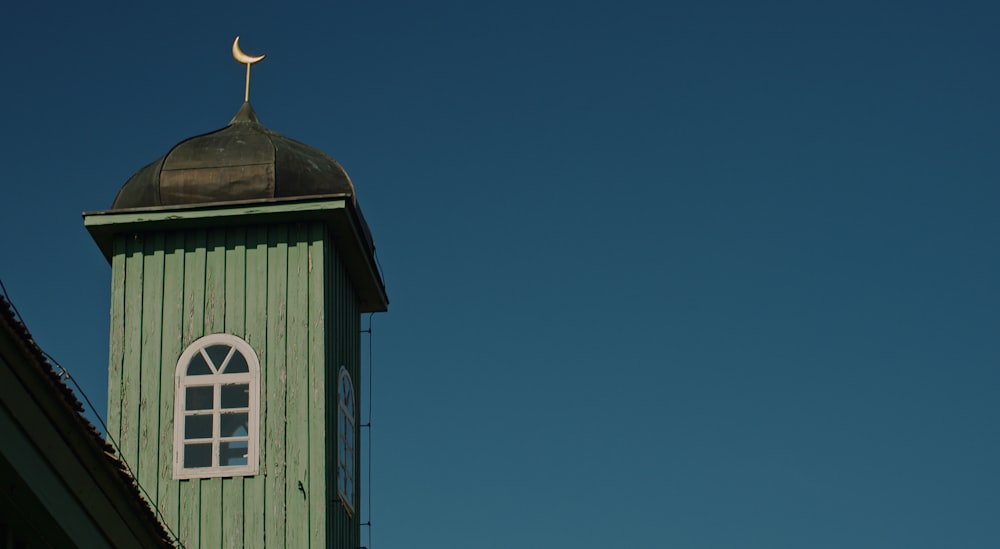 green and white wooden house under blue sky during daytime