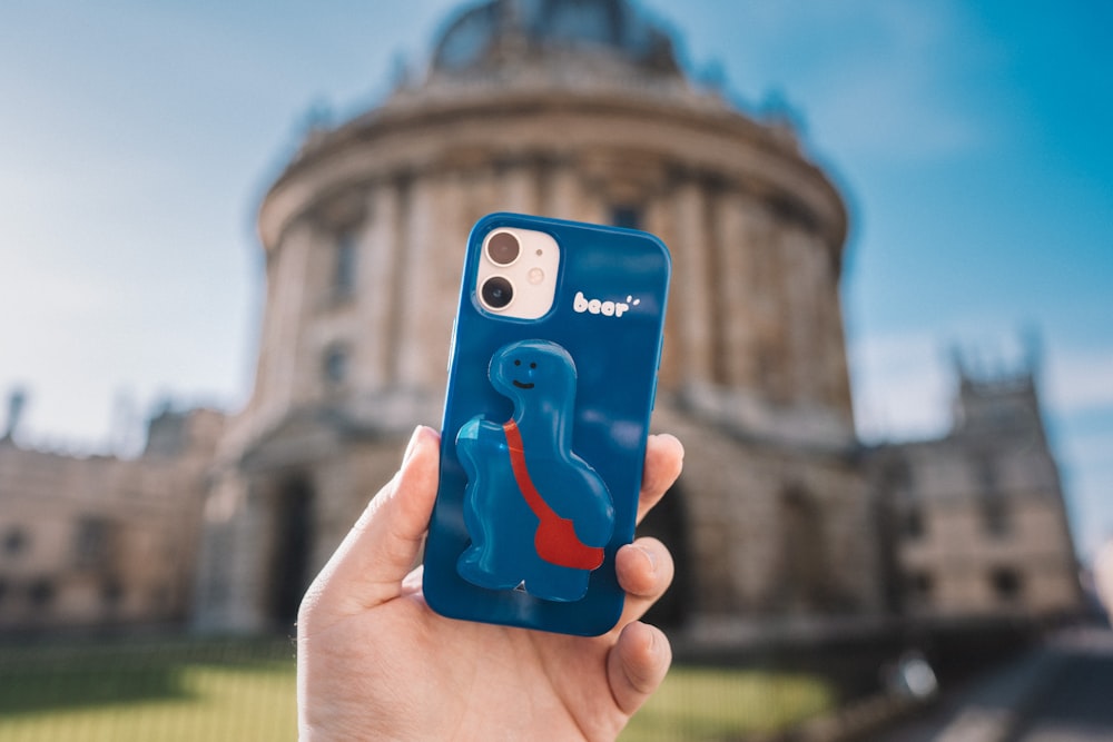 person holding blue iphone case