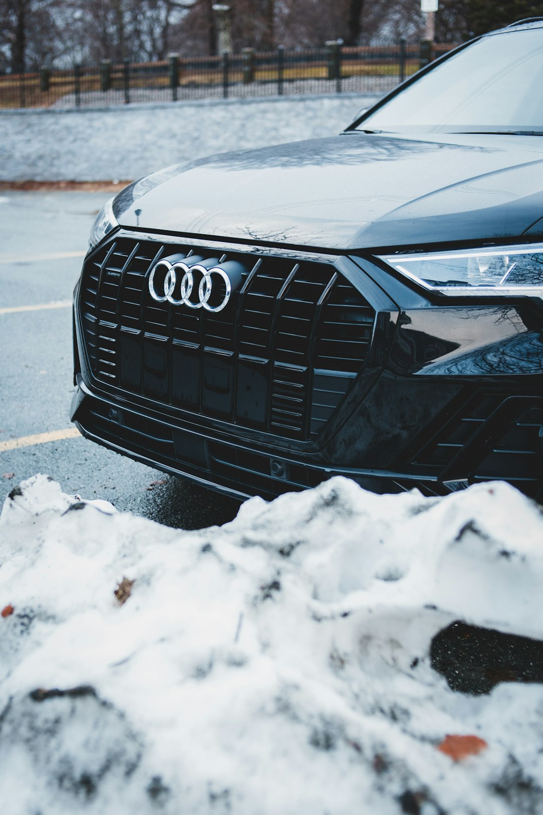 black audi car on road covered with snow