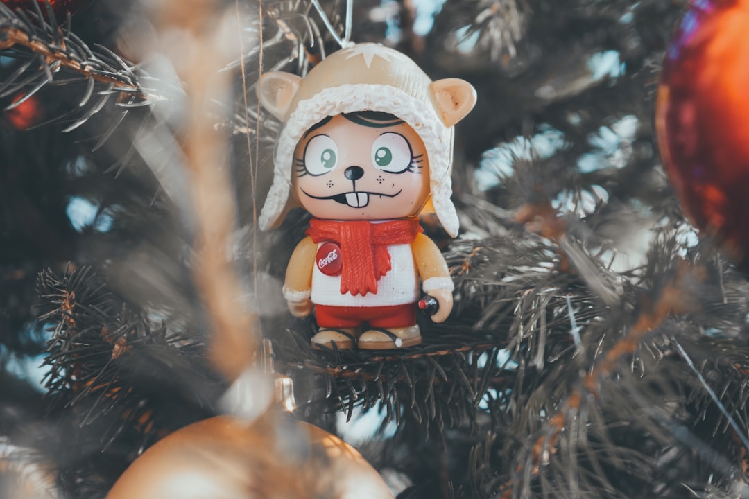 brown and red bear figurine on green christmas tree