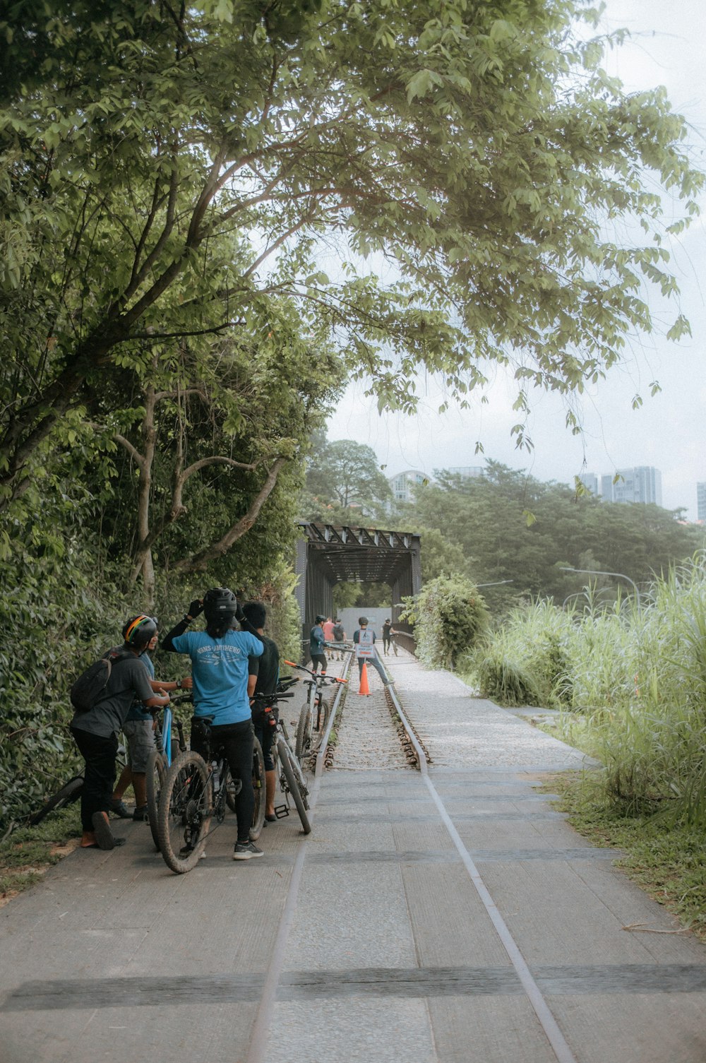 a group of people standing next to each other on a road