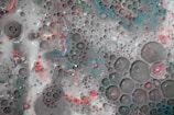 A close-up photo of colorful chemical reactions bubbling in glass beakers