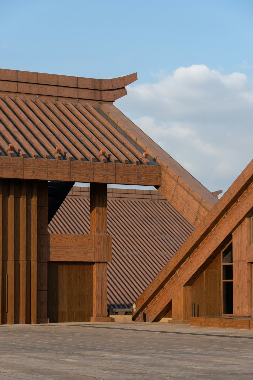 brown wooden building under white clouds during daytime