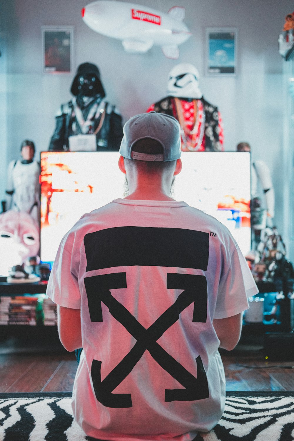 man in white and red crew neck t-shirt standing in front of store