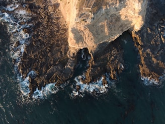 A stunning view of the rugged coastline of Baja California with waves crashing against the cliffs.