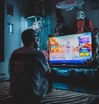 man in red shirt watching tv