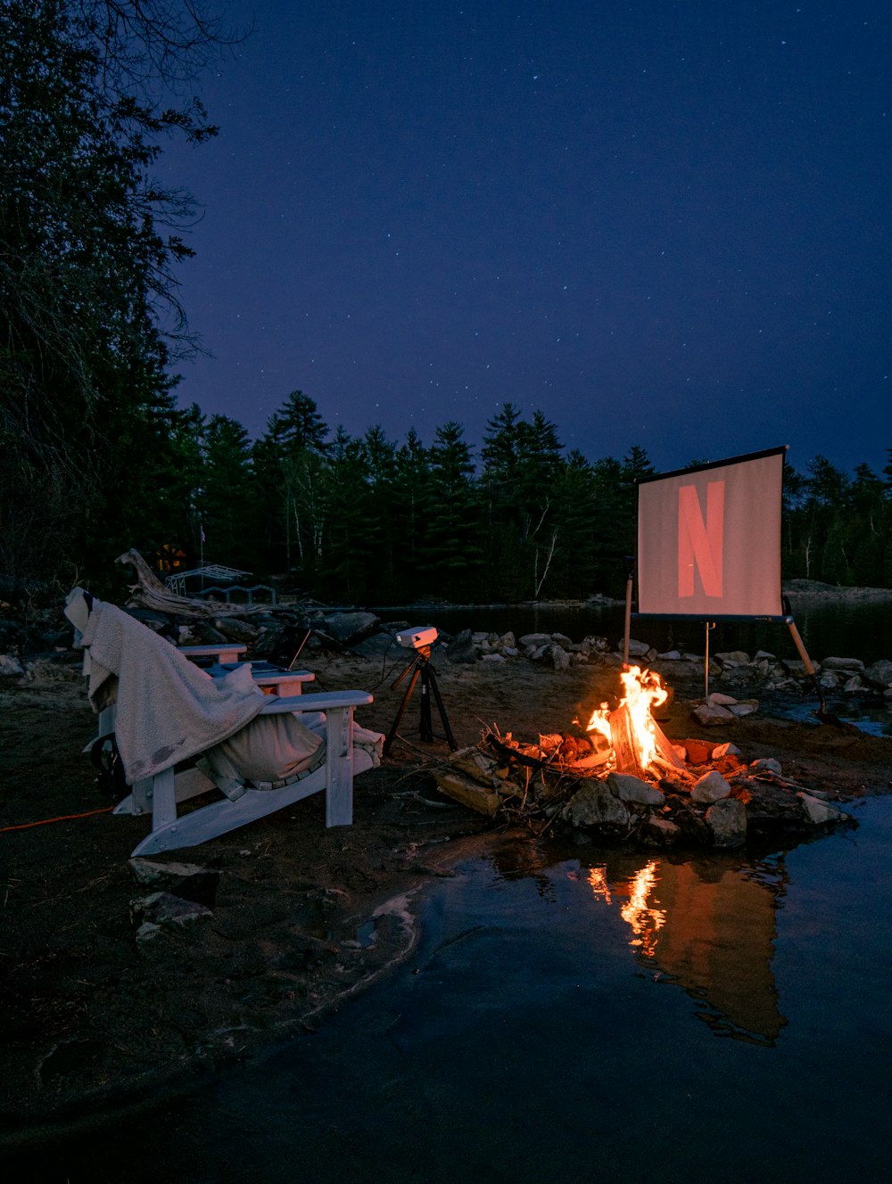 bonfire near body of water during night time