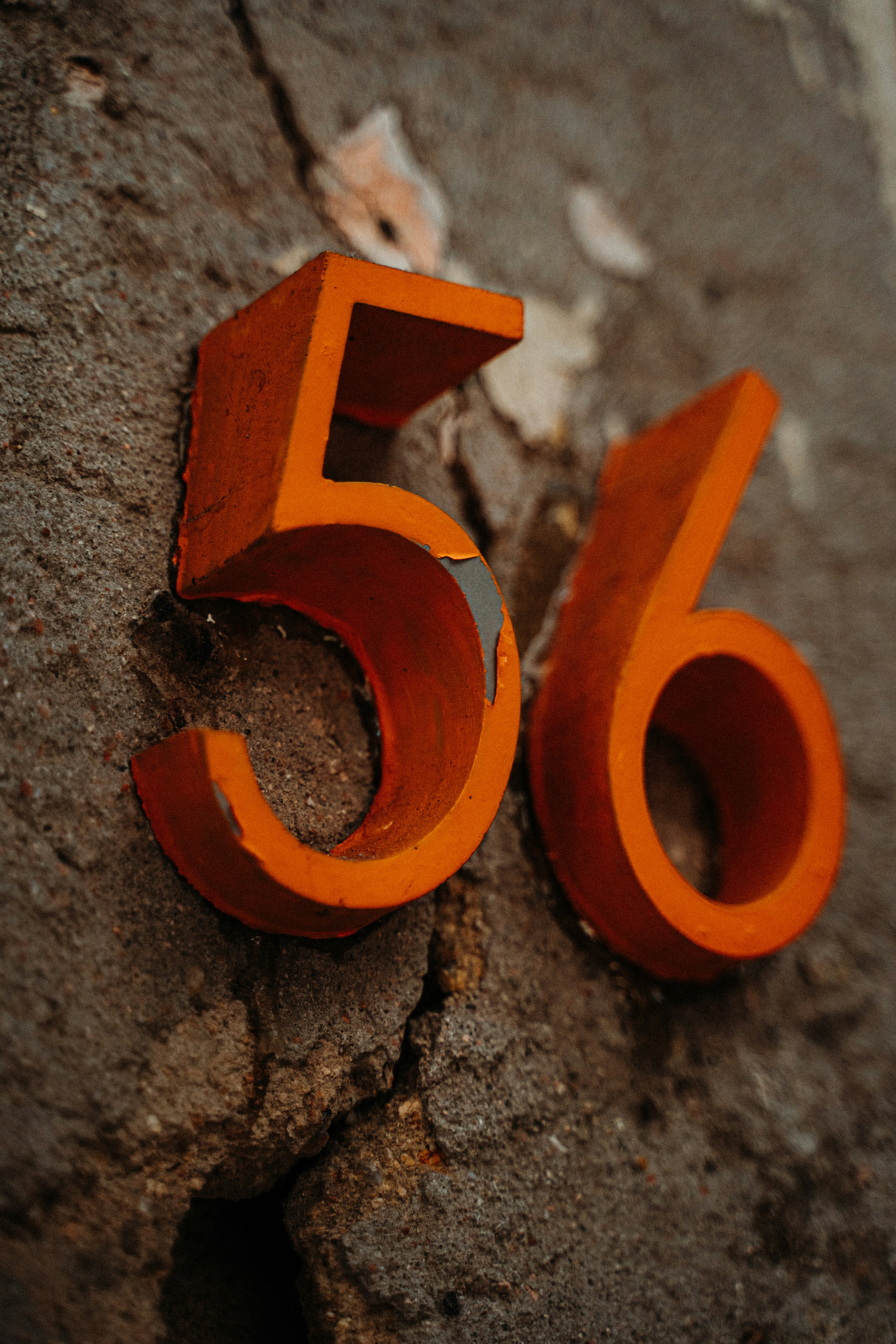 orange letter b on gray concrete surface