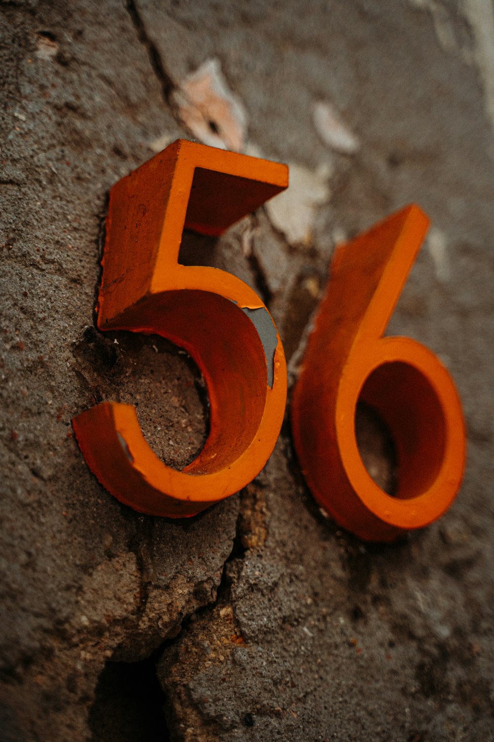 orange letter b on gray concrete surface