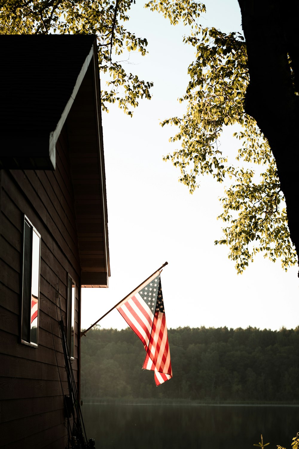 us a flag on white wooden house