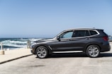 black suv parked on beach during daytime