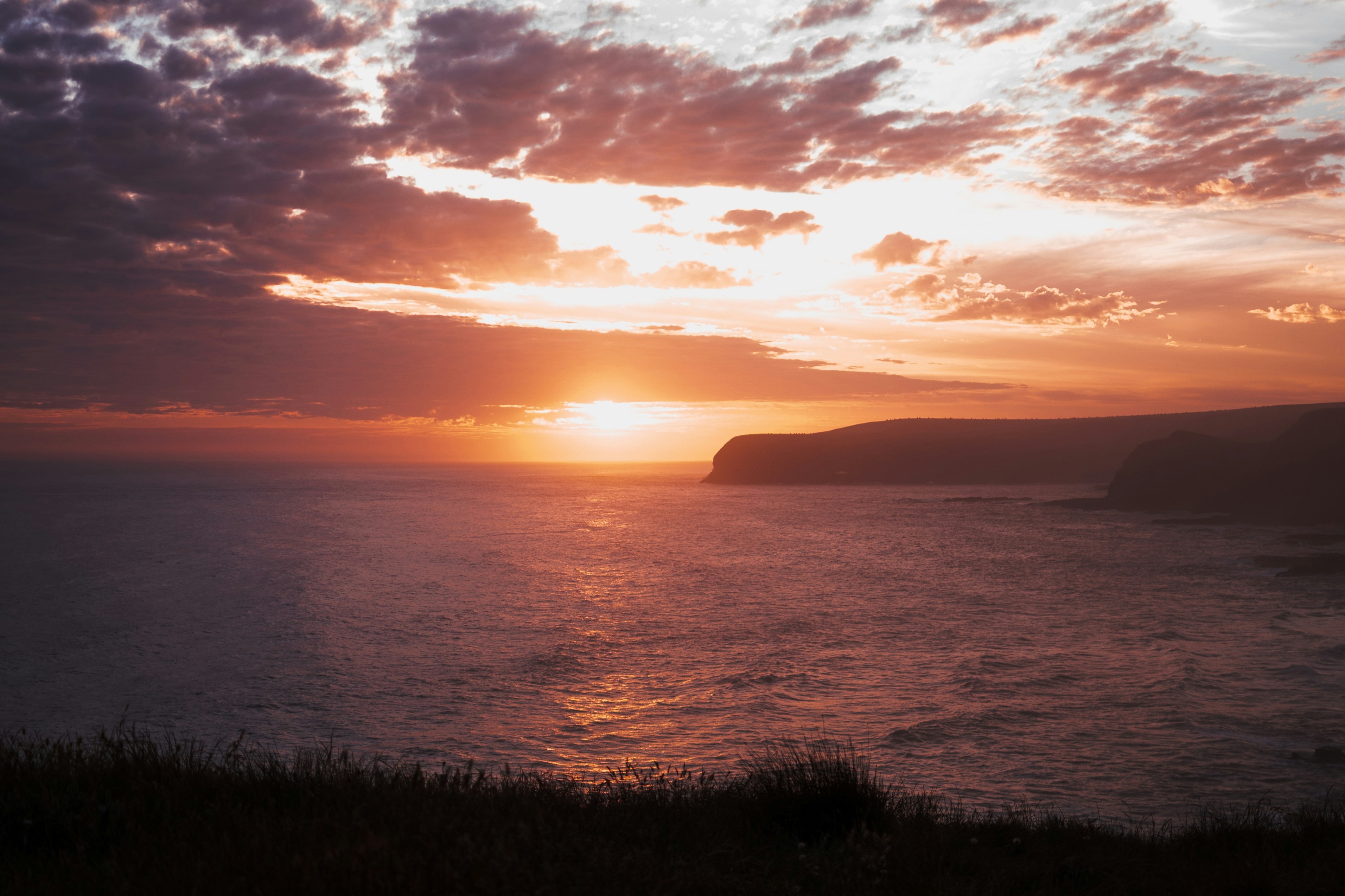 body of water under cloudy sky during daytime