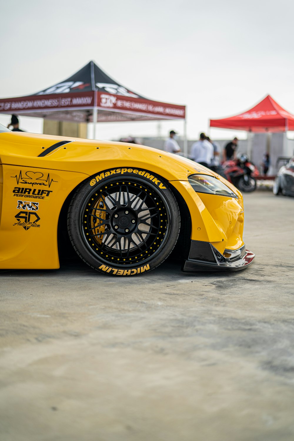 yellow ferrari f 1 on road during daytime