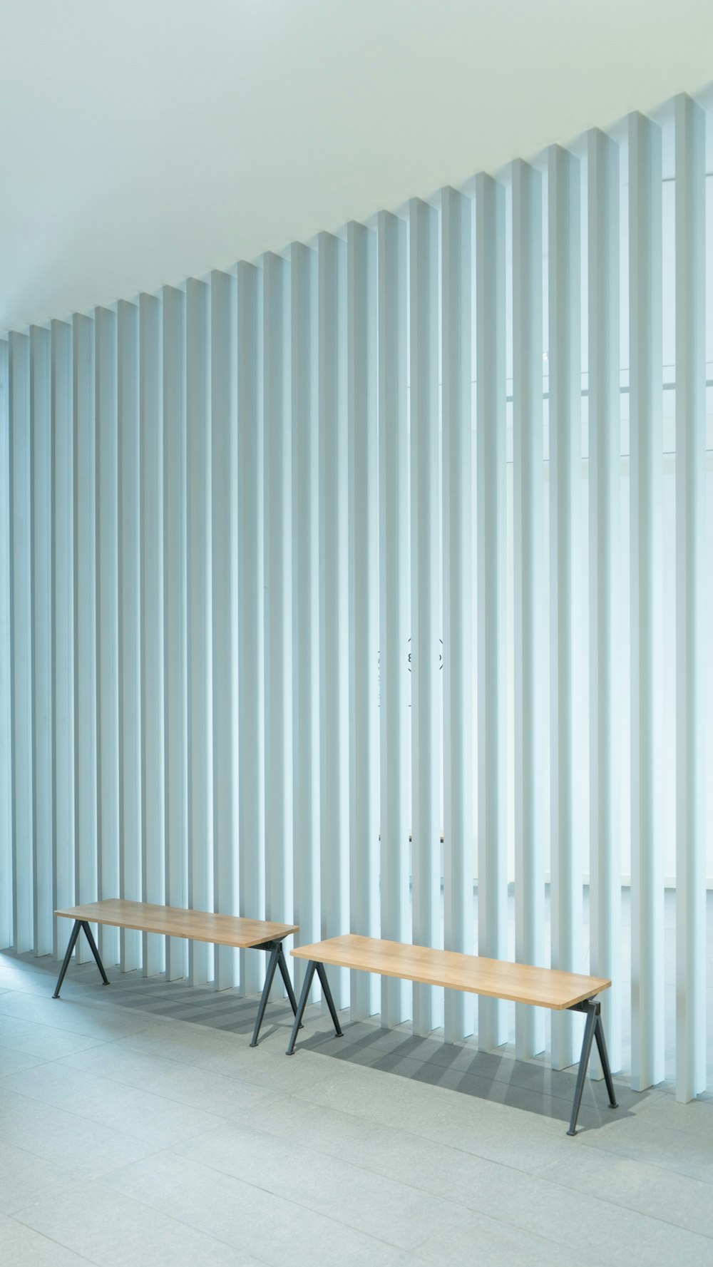 brown wooden folding chair beside white wall